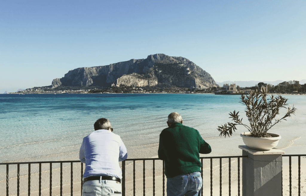 man in white shirt standing near body of water during daytime