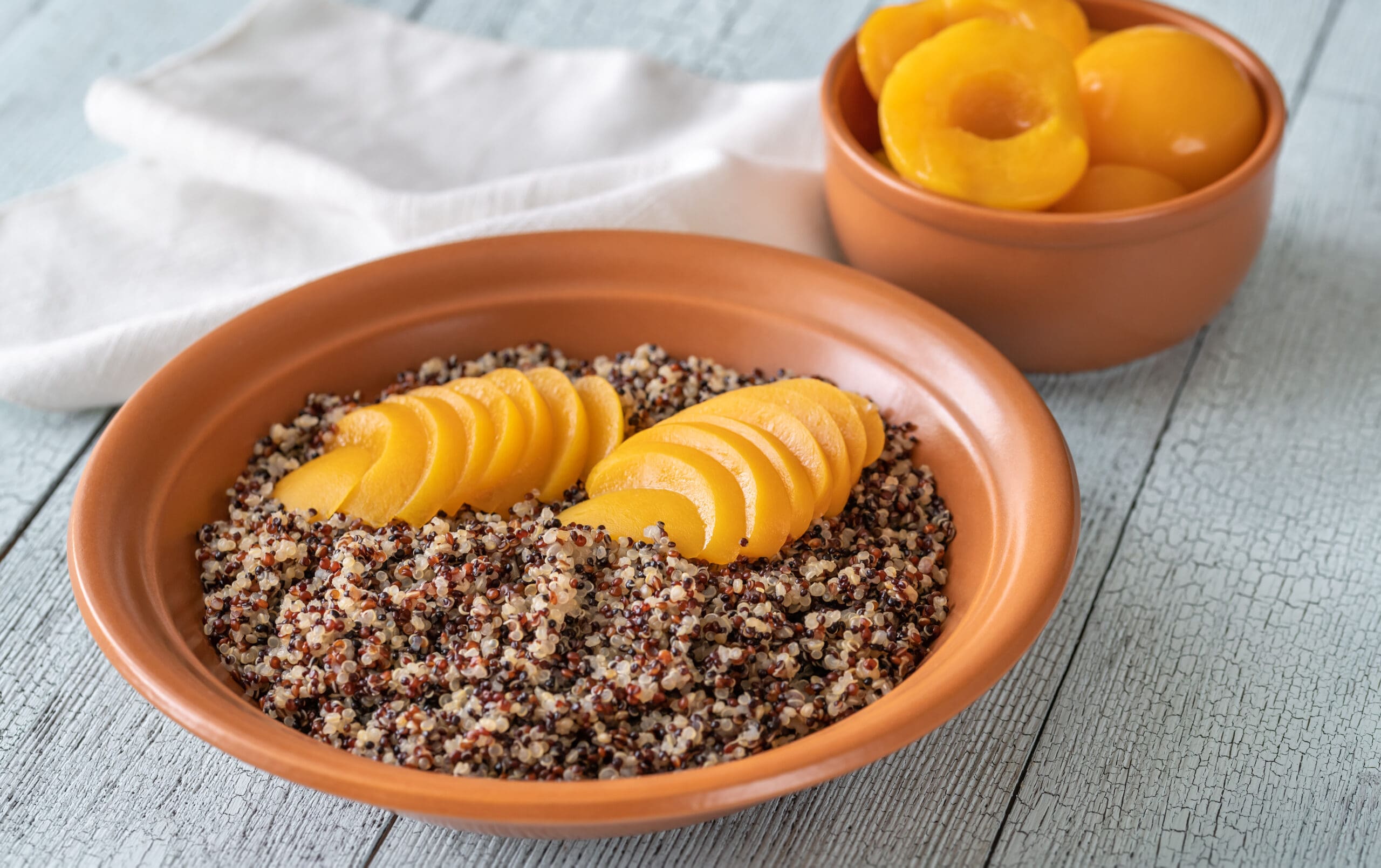 Quinoa with slices of peach in a bowl