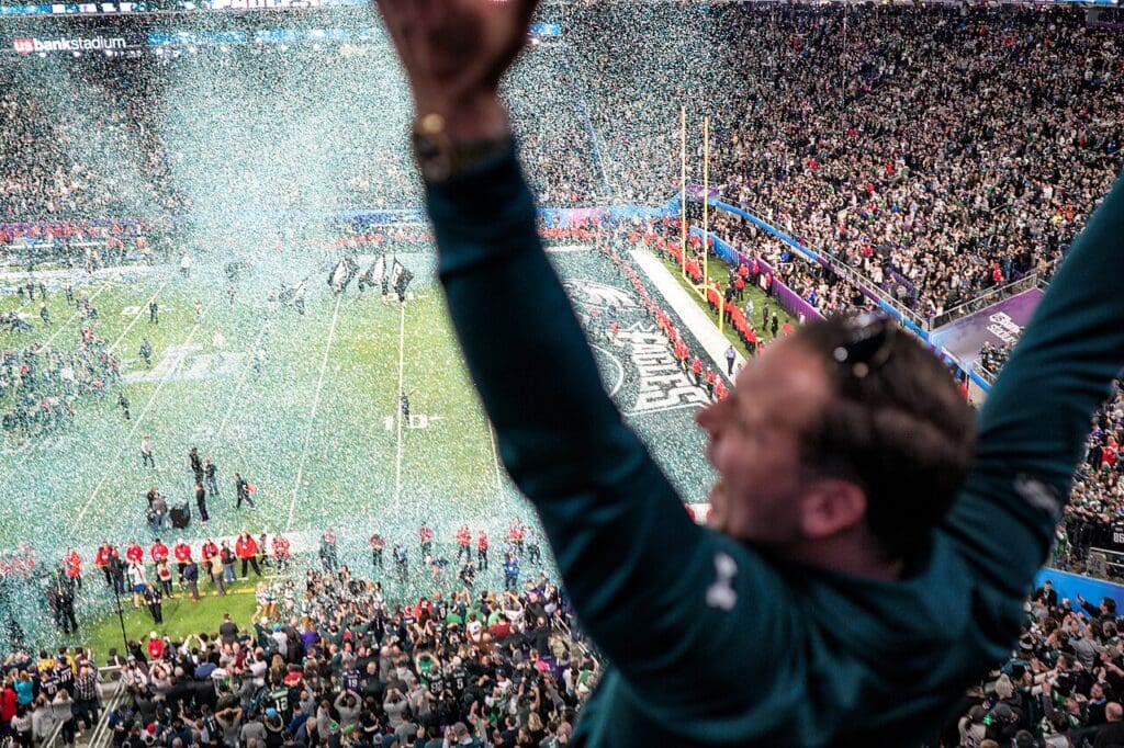 An Eagles fan celebrates as confetti falls on the field at Super Bowl 2018, Minneapolis