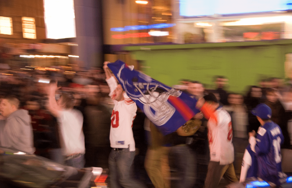 Excited New York Giants fans celebrate with team flag