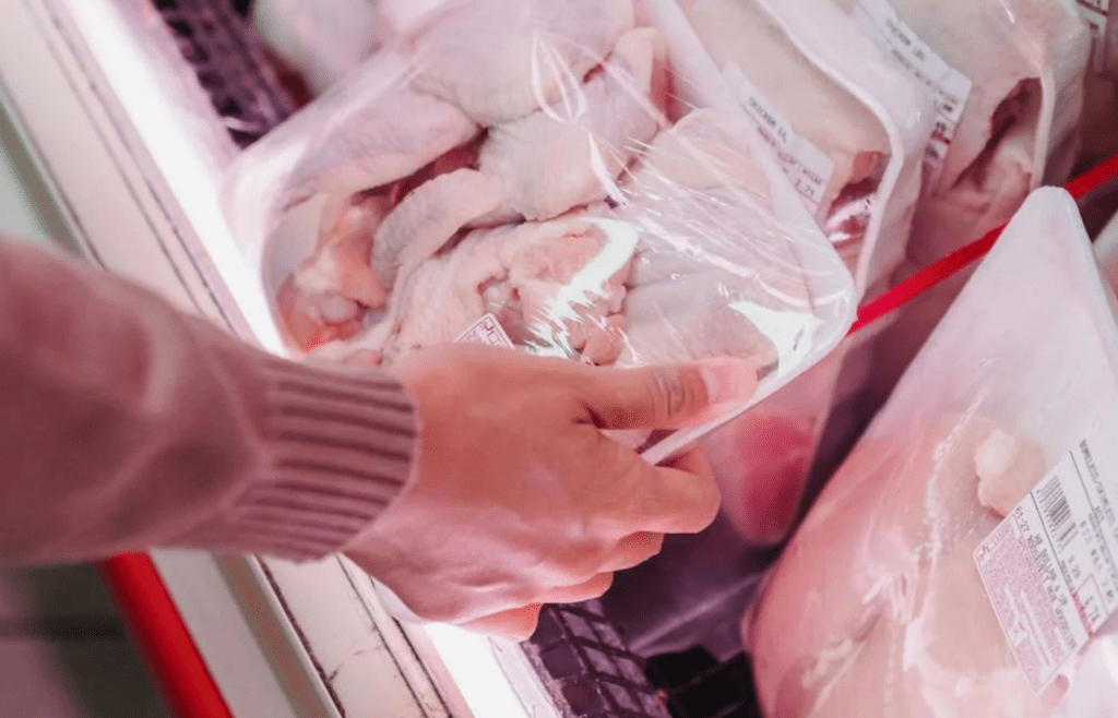 person holding chicken wings