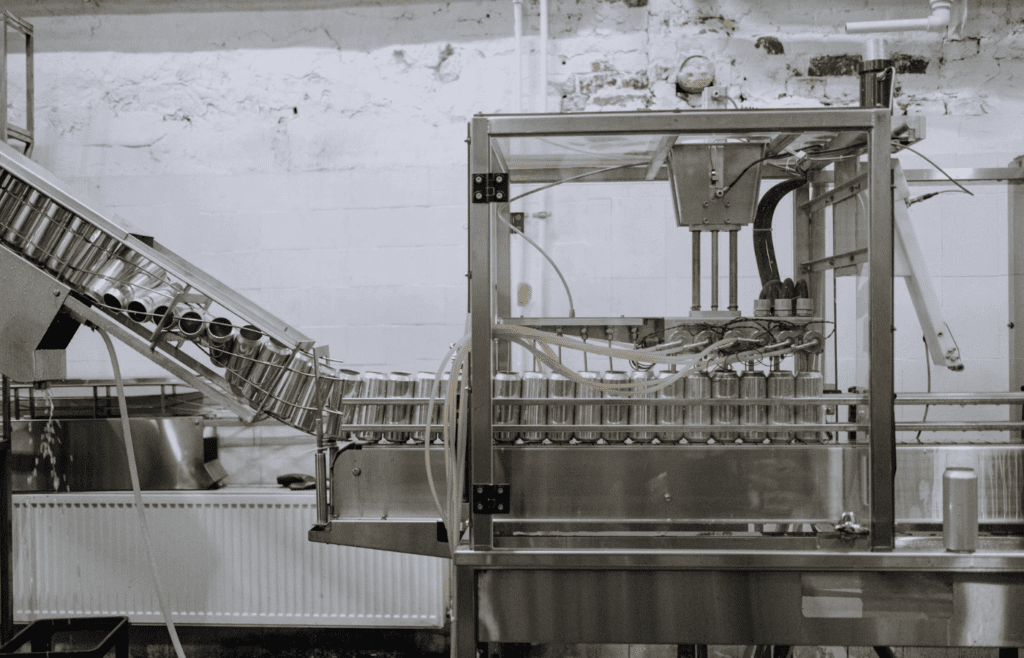 Automated machine inspecting cans on conveyor belt