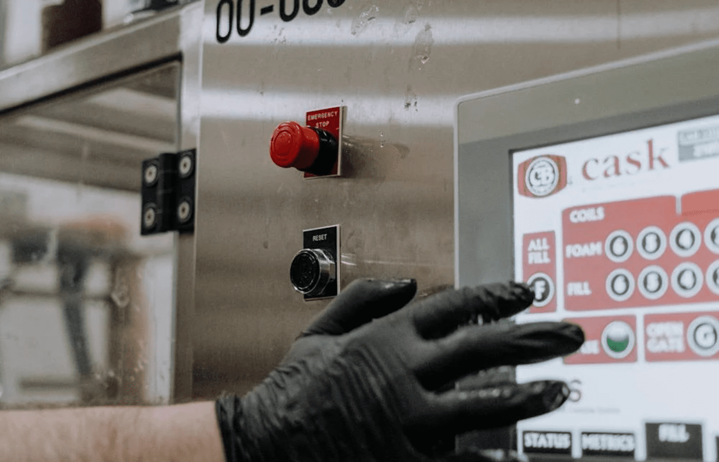 Person with Black Gloves in Hand using a touchscreen Machine