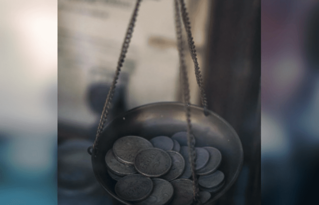 Close-Up Photograph of Coins on a Scale