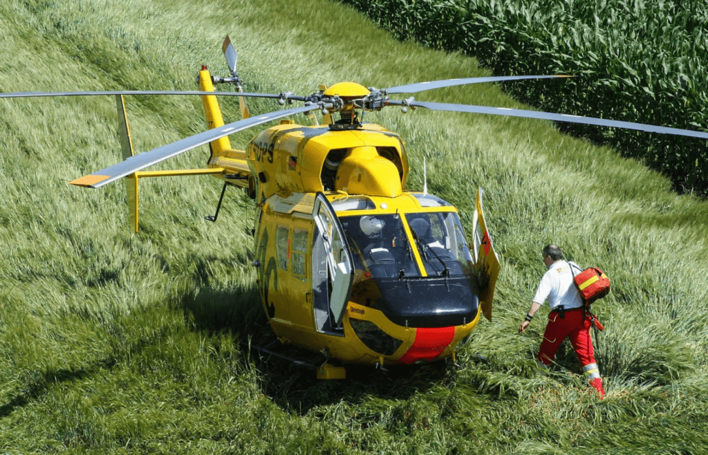 Paramedic walking toward helicopter in remote area