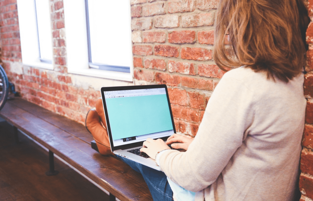 Woman researching global health news on laptop