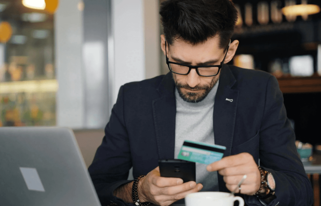Man reviewing automatic bank transfers on phone