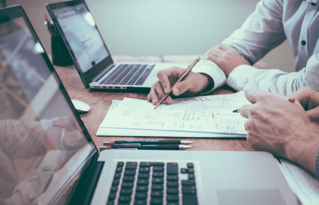 Person reviewing financial charts with advisor