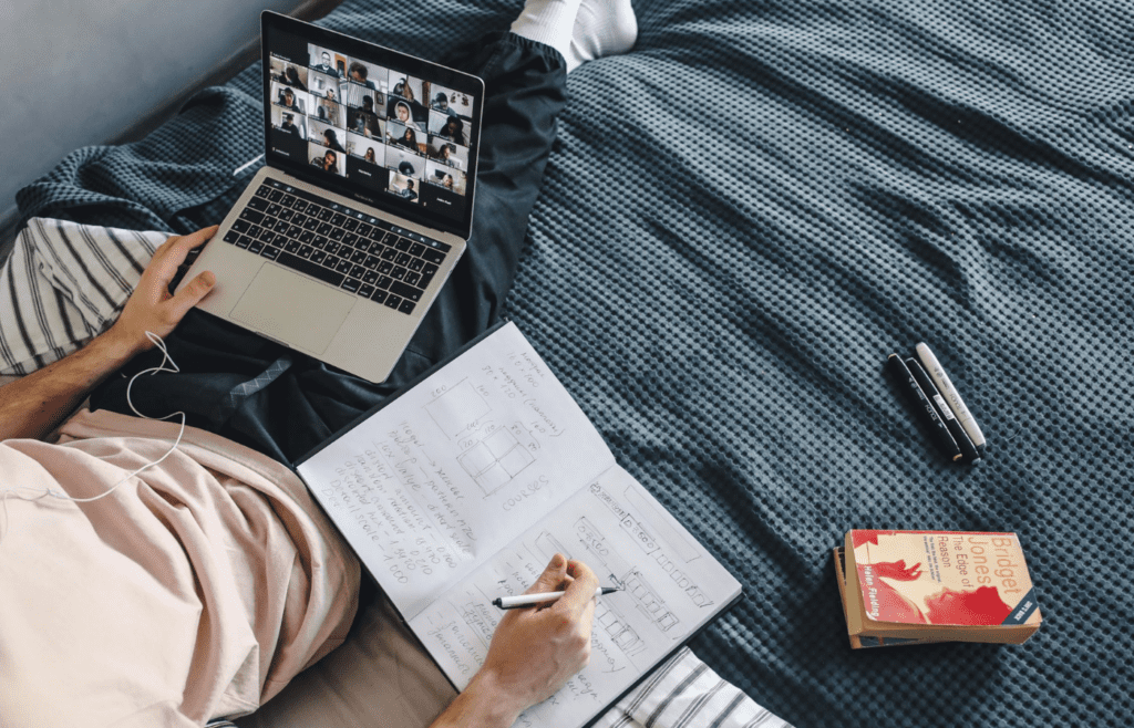 A Man Sitting on the Bed and taking an online course