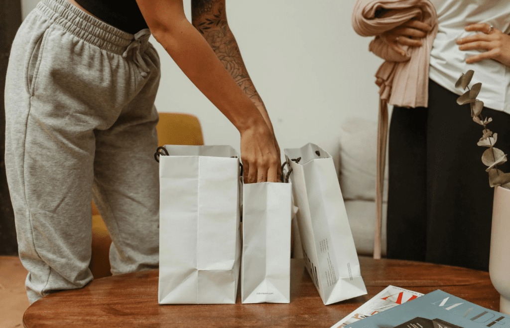 Shopping bags and magazines on brown table