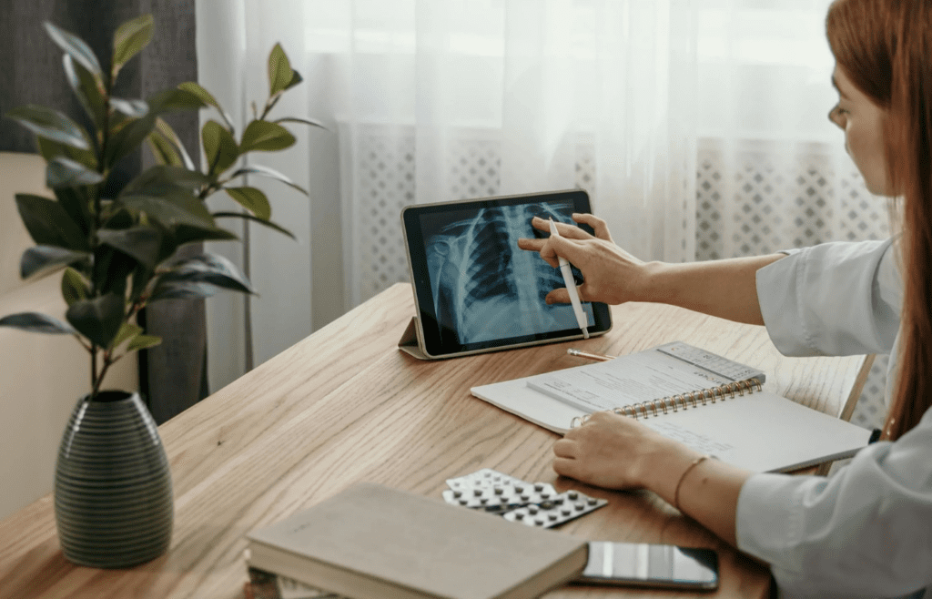 Doctor reviewing digital chest x-ray on tablet