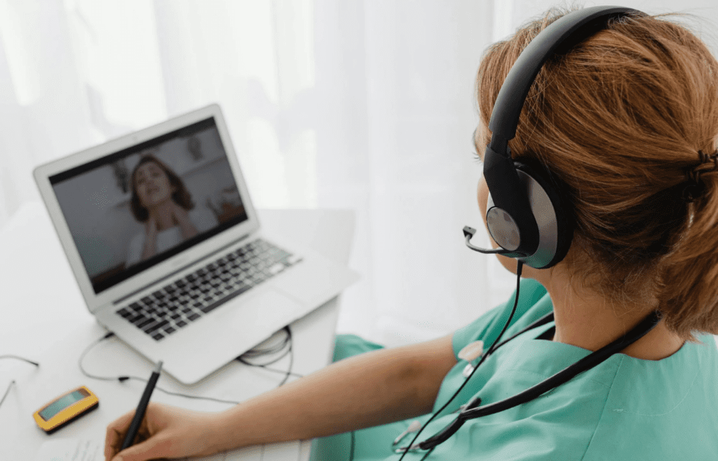 Lady Doctor Wearing Headphones While Video Calling to Patient