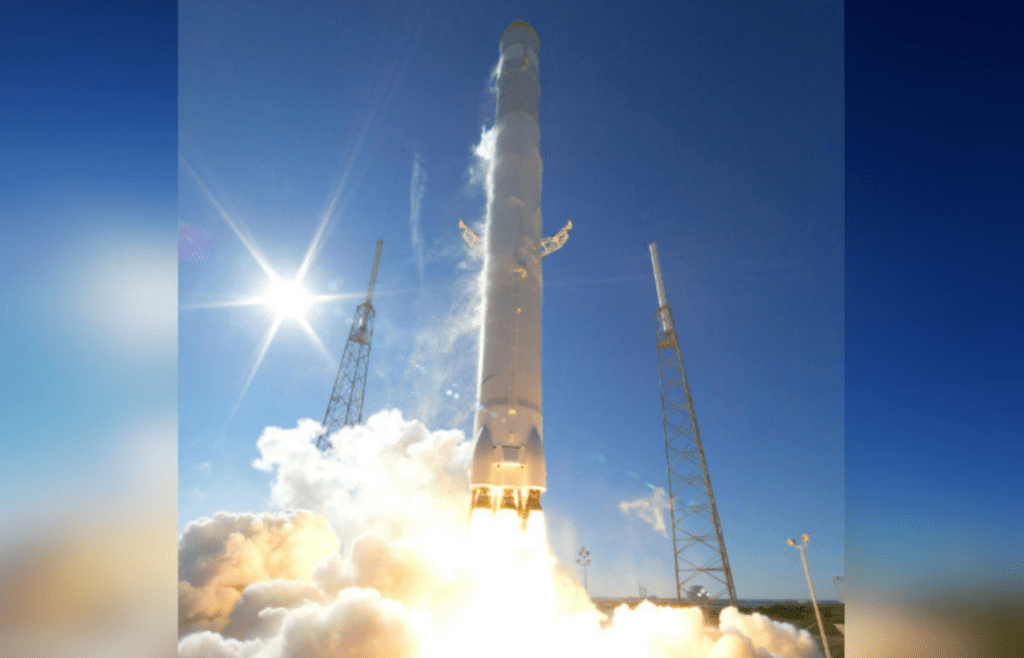 Sleek silver rocket launches into clear sky