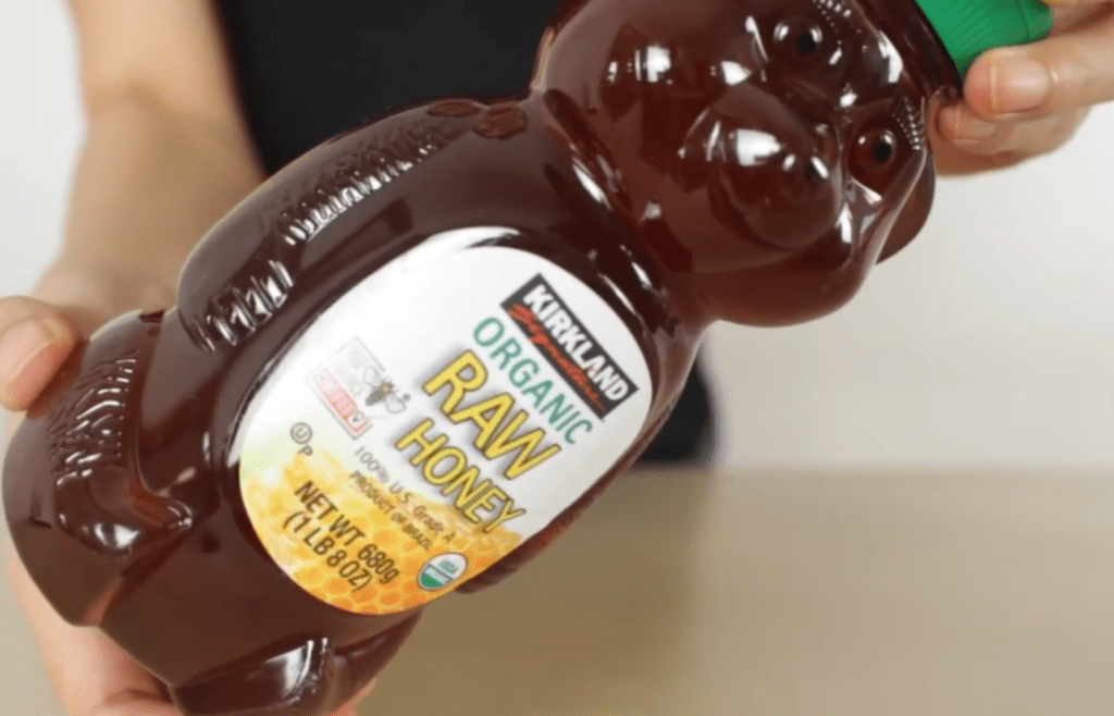 Kirkland honey bottle in hand