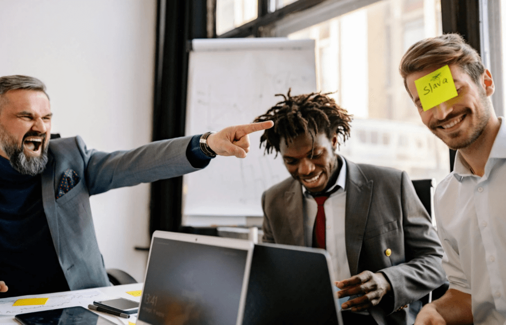 A Man Laughing at the Employee with Sticky Note on His Head