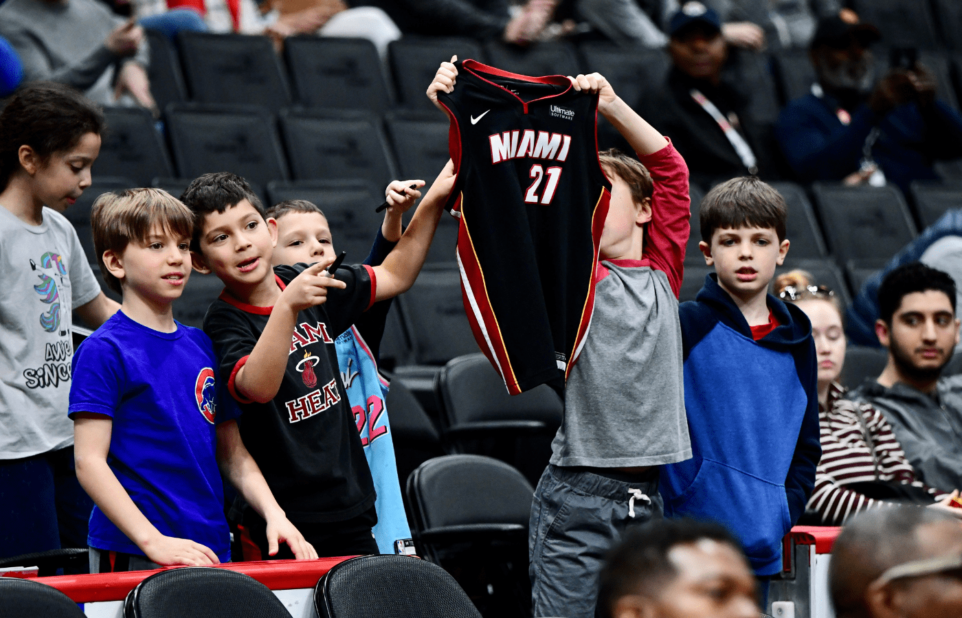 Young Miami Heat fans cheer in the stands