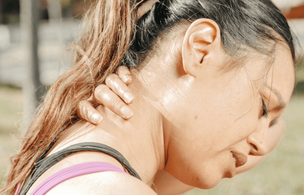 A person massaging their neck or shoulders