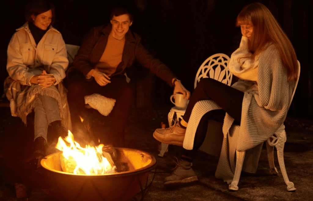 A small backyard fire pit surrounded by chairs
