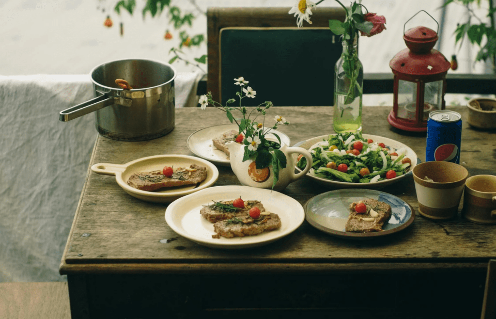 A table set outdoors with simple dishes and fresh flowers