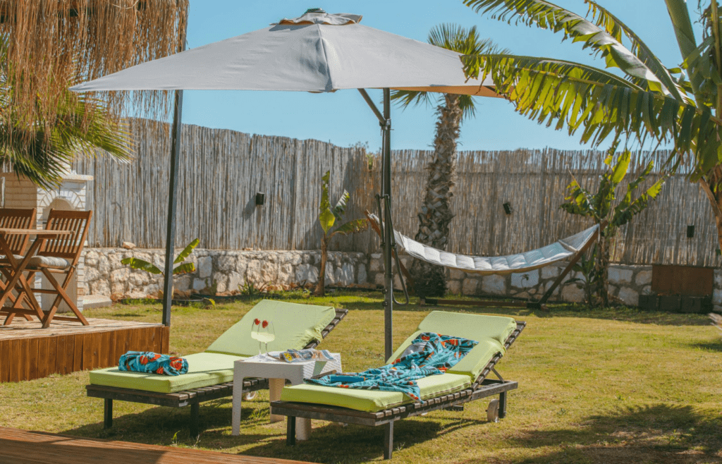 A pergola or umbrella shading a comfy seating area