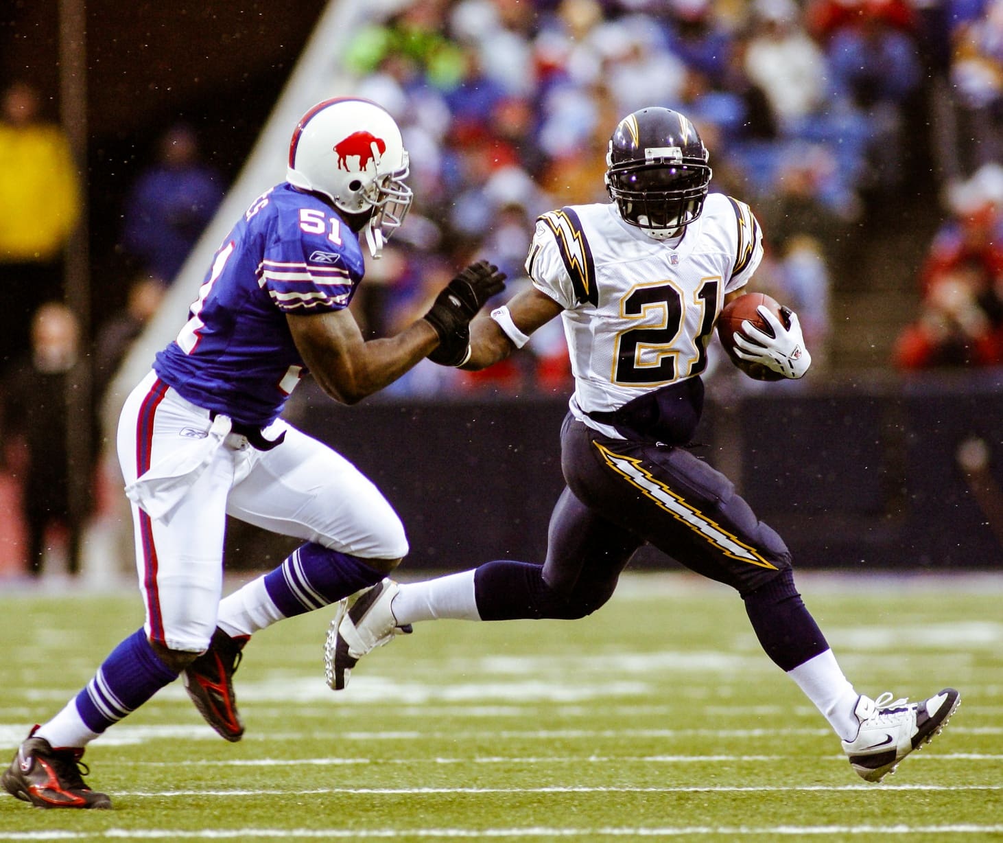 Dec 3, 2006; Orchard Park, NY, USA: FILE PHOTO; San Diego Chargers running back LaDainian Tomlinson (21) against Buffalo Bills linebacker Takeo Spikes (51) at Ralph Wilson Stadium. Mandatory Credit: Richard Mackson-USA TODAY Network