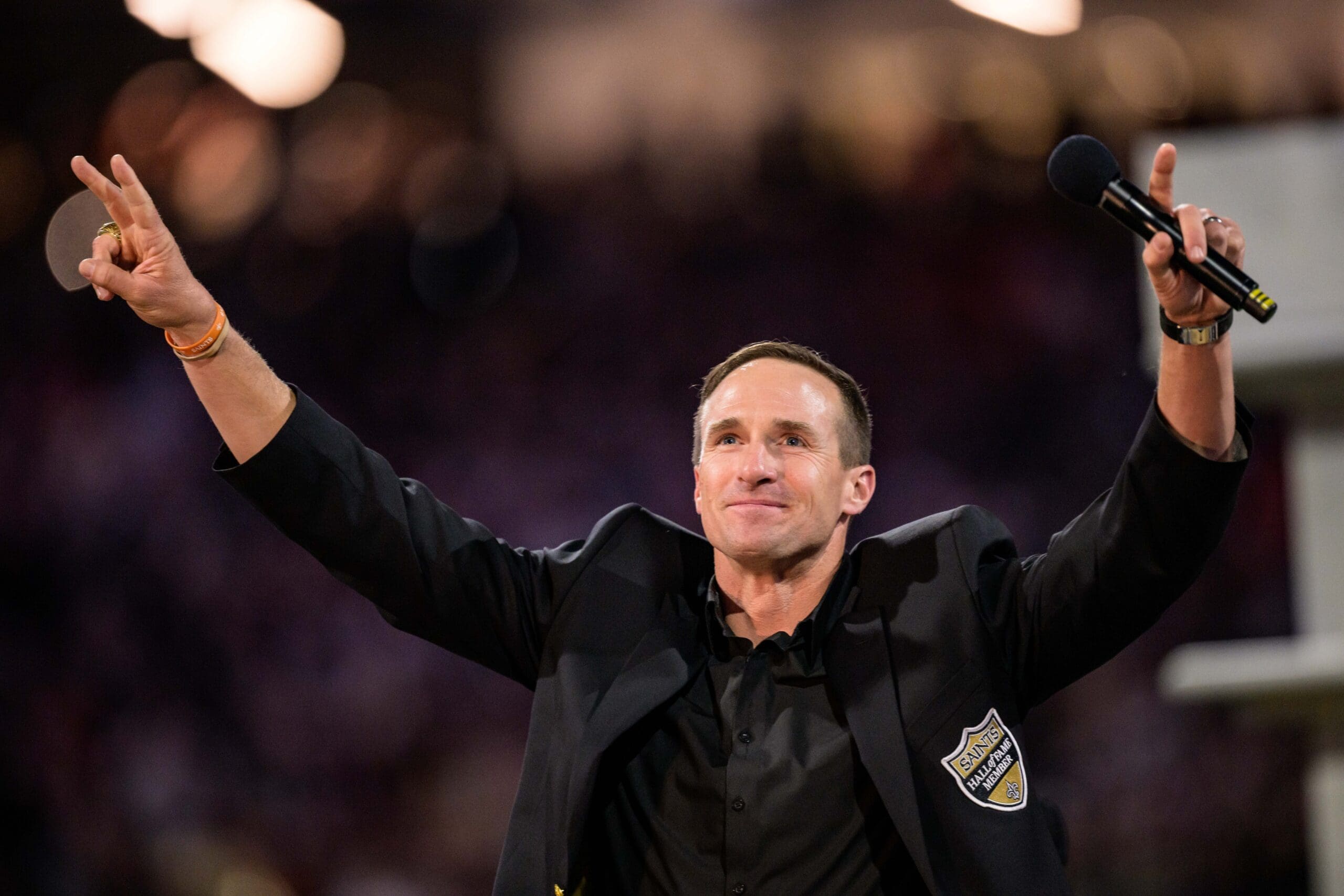Oct 17, 2024; New Orleans, Louisiana, USA; New Orleans Saints retired quarterback Drew Brees (9) reacts during his hall of fame ceremony at halftime against the Denver Broncos at Caesars Superdome. Mandatory Credit: Matthew Hinton-Imagn Images
