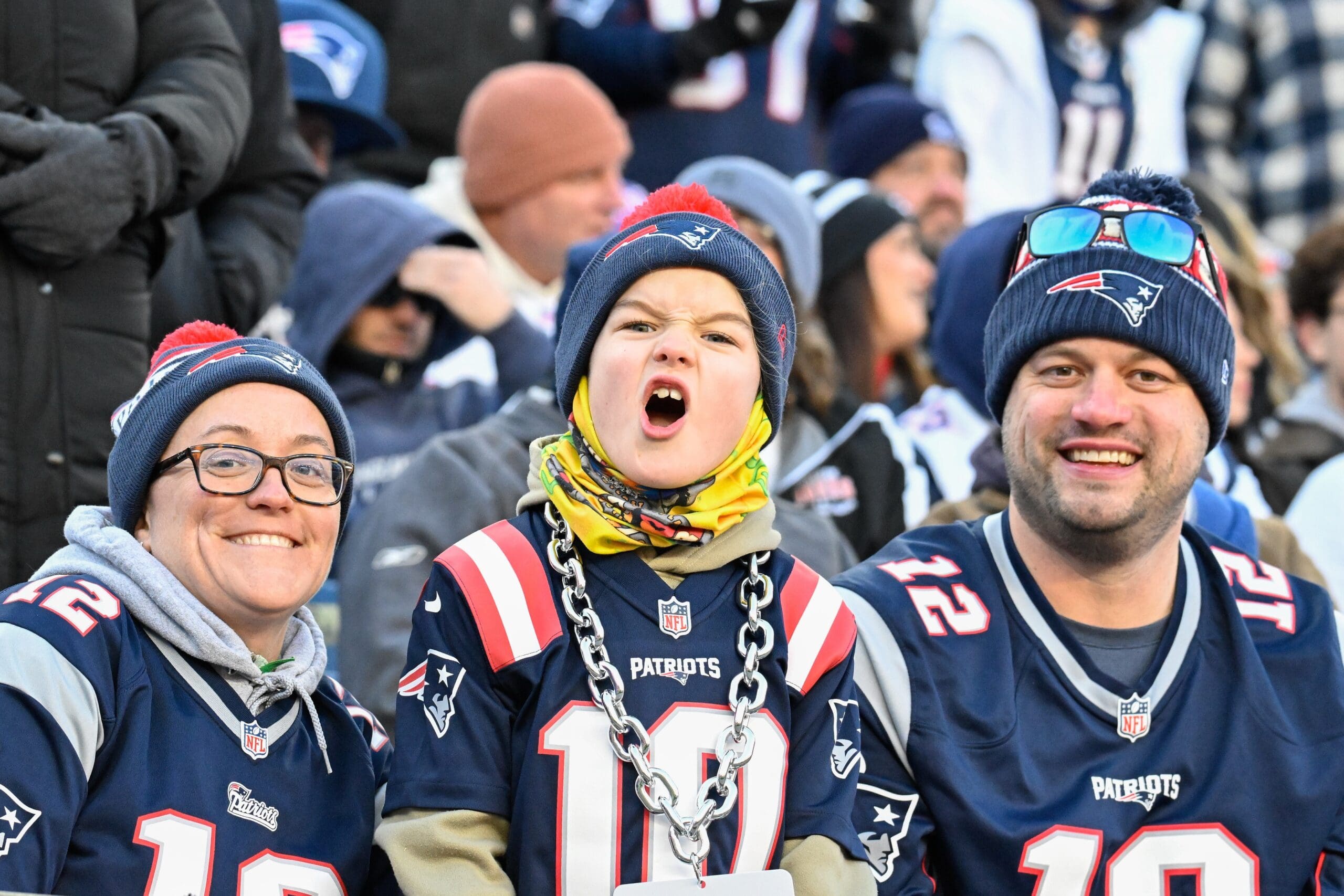 Dec 1, 2024; Foxborough, Massachusetts, USA; A young New England Patriots fan cheers for the team during the first half against the Indianapolis Colts at Gillette Stadium. Mandatory Credit: Eric Canha-Imagn Images