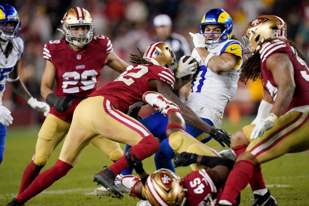 Dec 12, 2024; Santa Clara, California, USA; Los Angeles Rams wide receiver Puka Nacua (17) is tackled by San Francisco 49ers cornerback Isaac Yiadom (22) after making a catch in the fourth quarter at Levi's Stadium. Mandatory Credit: Cary Edmondson-Imagn Images