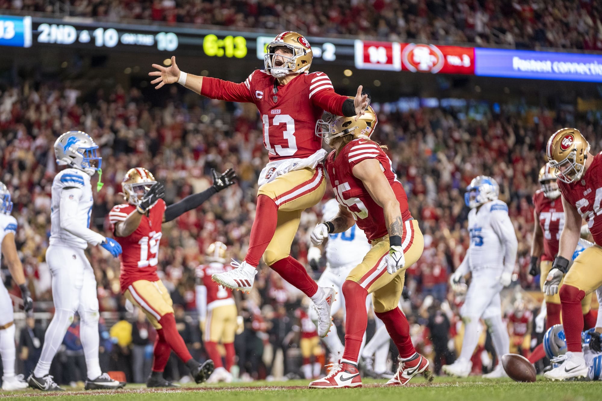 December 30, 2024; Santa Clara, California, USA; San Francisco 49ers quarterback Brock Purdy (13) celebrates with tight end George Kittle (85) after scoring a touchdown against the Detroit Lions during the second quarter at Levi's Stadium. Mandatory Credit: Kyle Terada-Imagn Images