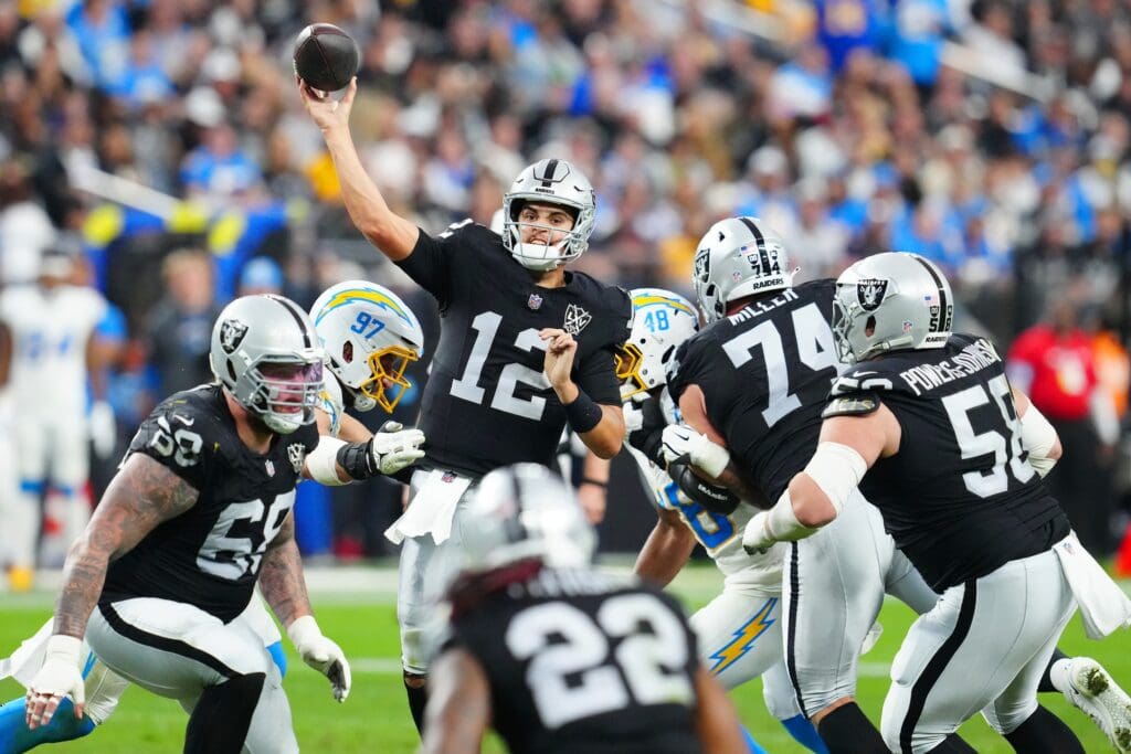 Jan 5, 2025; Paradise, Nevada, USA; Las Vegas Raiders quarterback Aidan O'Connell (12) makes a pass attempt against the Los Angeles Chargers during the fourth quarter at Allegiant Stadium. Mandatory Credit: Stephen R. Sylvanie-Imagn Images