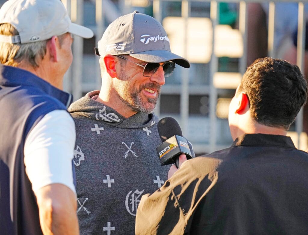 FeJets quarterback Aaron Rodgers talks with the press on the first tee box during the Phoenix Open Annexus Pro-Am at TPC Scottsdale.