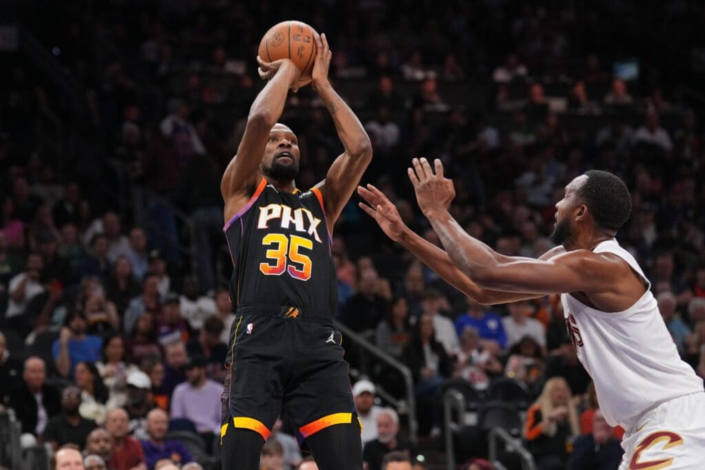 Mar 21, 2025; Phoenix, Arizona, USA; Phoenix Suns forward Kevin Durant (35) shoots against Cleveland Cavaliers forward Evan Mobley (4) during the second half at Footprint Center. Mandatory Credit: Joe Camporeale-Imagn Images