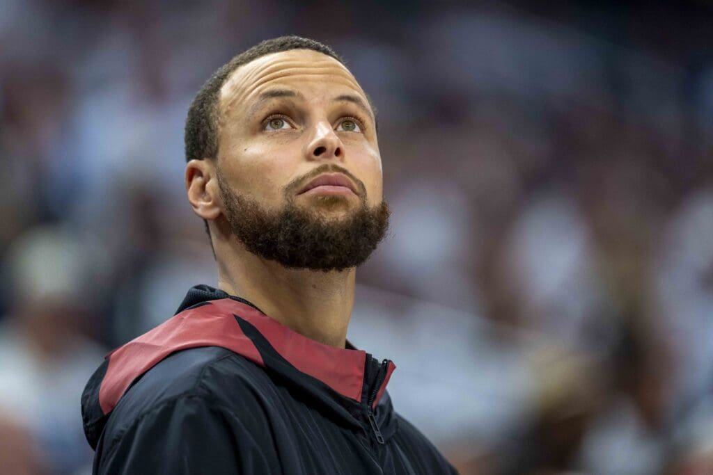 May 8, 2025; Minneapolis, Minnesota, USA; Golden State Warriors guard Stephen Curry (30) looks on from the bench against the Minnesota Timberwolves in the second half during game two of the second round for the 2025 NBA Playoffs at Target Center. Mandatory Credit: Jesse Johnson-Imagn Images