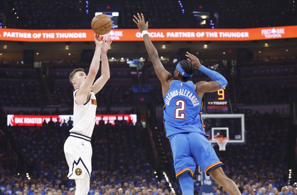 May 18, 2025; Oklahoma City, Oklahoma, USA; Denver Nuggets guard Christian Braun (0) shoots as Oklahoma City Thunder guard Shai Gilgeous-Alexander (2) defends in the first quarter during game seven of the second round for the 2025 NBA Playoffs at Paycom Center.
