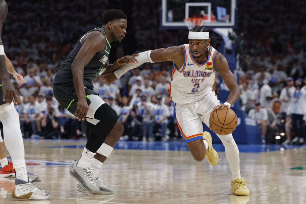 May 20, 2025; Oklahoma City, Oklahoma, USA; Oklahoma City Thunder guard Shai Gilgeous-Alexander (2) drives against Minnesota Timberwolves guard Anthony Edwards (5) in the fourth quarter during game one of the western conference finals for the 2025 NBA Playoffs at Paycom Center.