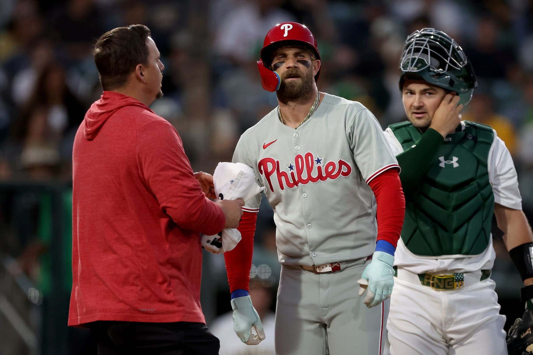 May 23, 2025; West Sacramento, California, USA; Philadelphia Phillies first baseman Bryce Harper (3) is looked at by a trainer after being hit by a pitch against the Athletics during the sixth inning at Sutter Health Park. Mandatory Credit: Dennis Lee-Imagn Images