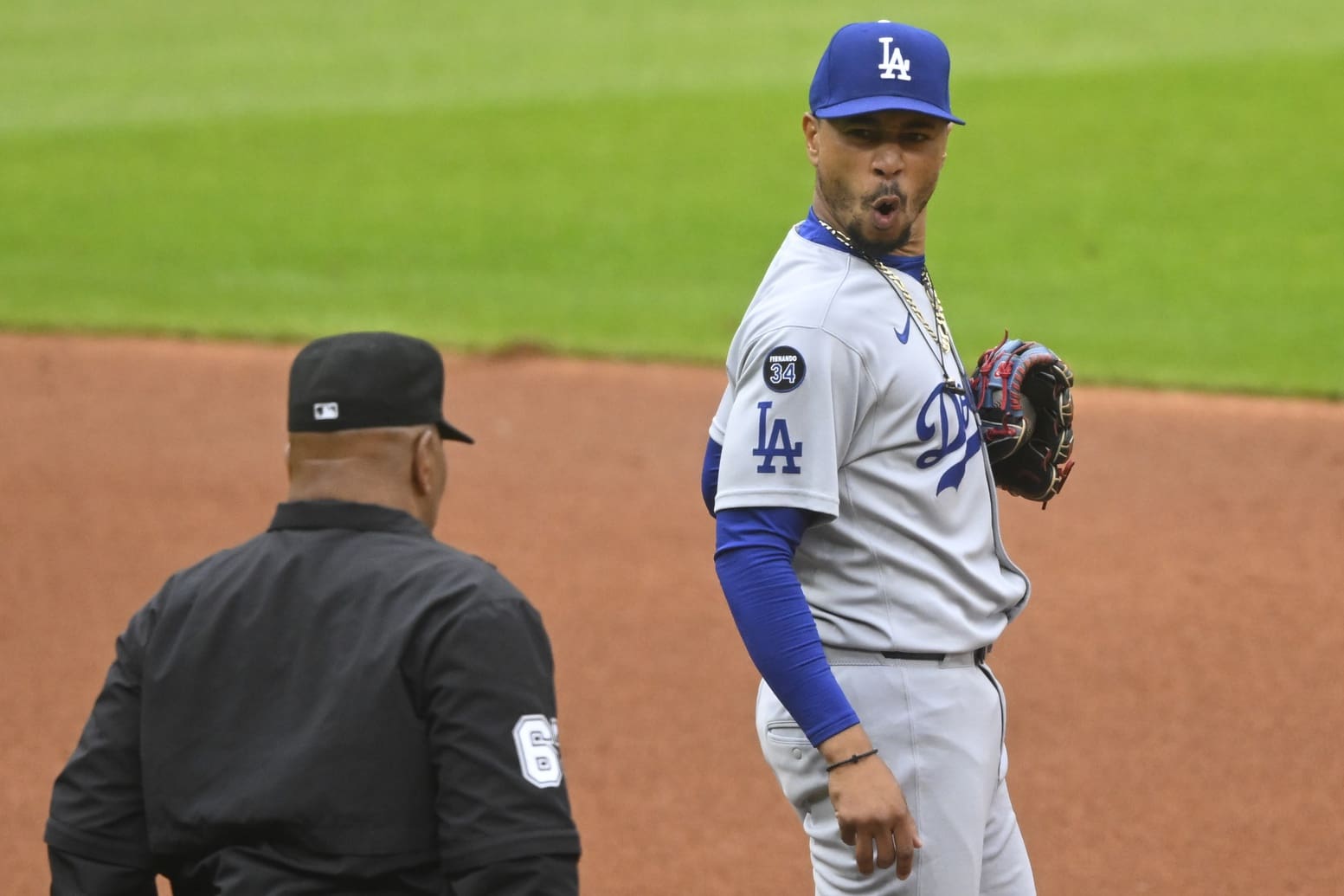 May 27, 2025; Cleveland, Ohio, USA; Los Angeles Dodgers shortstop Mookie Betts (50) reacts to a call by umpire Laz Diaz (63) in the first inning against the Cleveland Guardians at Progressive Field. Mandatory Credit: David Richard-Imagn Images
