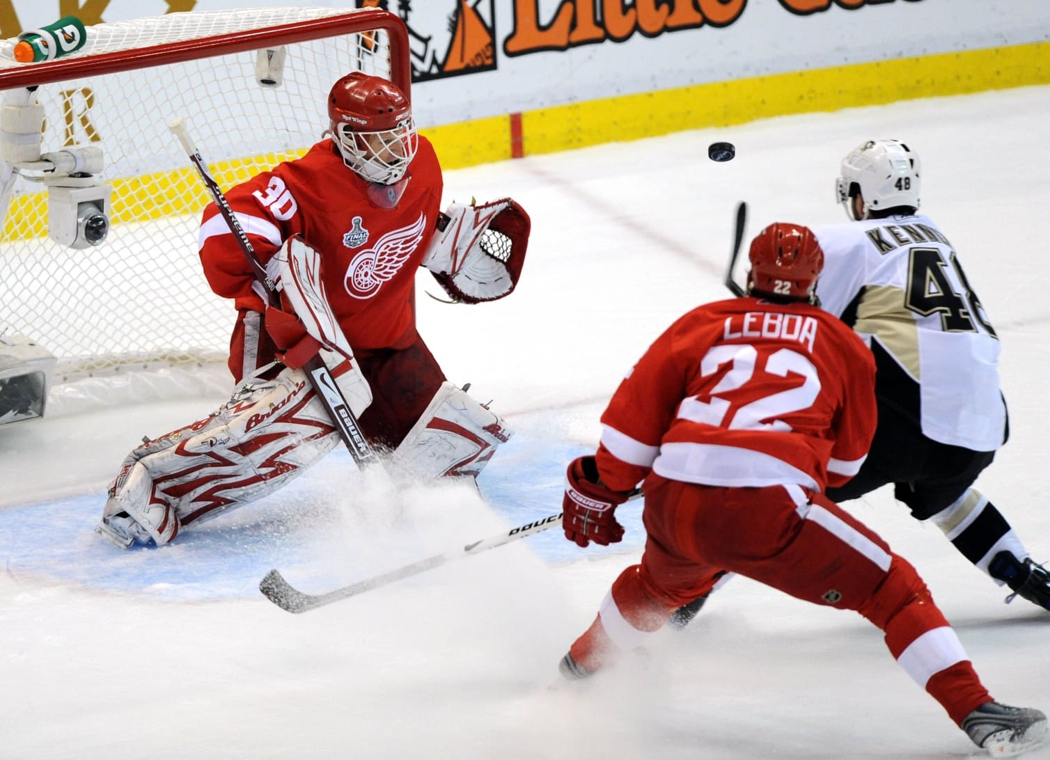 May 30, 2009; Detroit, MI, USA; Detroit Red Wings goalie Chris Osgood (30) and defenseman Brett Lebda (22) watch as a shot by Pittsburgh Penguins center Tyler Kennedy (48) sails wide of the net in the first period of game one of the 2009 Stanley Cup finals at Joe Louis Arena. Mandatory Credit: Leon Halip-USA TODAY Sports