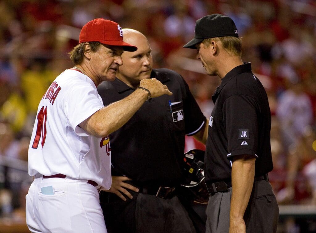 June 28, 2010; St. Louis, MO, USA; After getting ejected St. Louis Cardinals manager Tony La Russa (10) argues the strike zone with home plate umpire Mark Carlson (center) and crew chief Angel Campos at Busch Stadium. Mandatory Credit: Scott Rovak-USA TODAY Sports