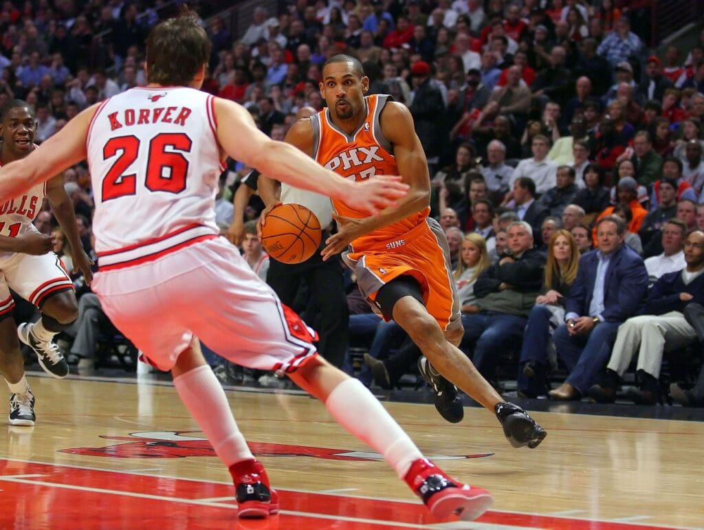 Apr 5, 2011; Chicago, IL, USA; Phoenix Suns small forward Grant Hill (33) is defended by Chicago Bulls shooting guard Kyle Korver (26) in the first half at the United Center. Mandatory Credit: Dennis Wierzbicki-USA TODAY Sports
