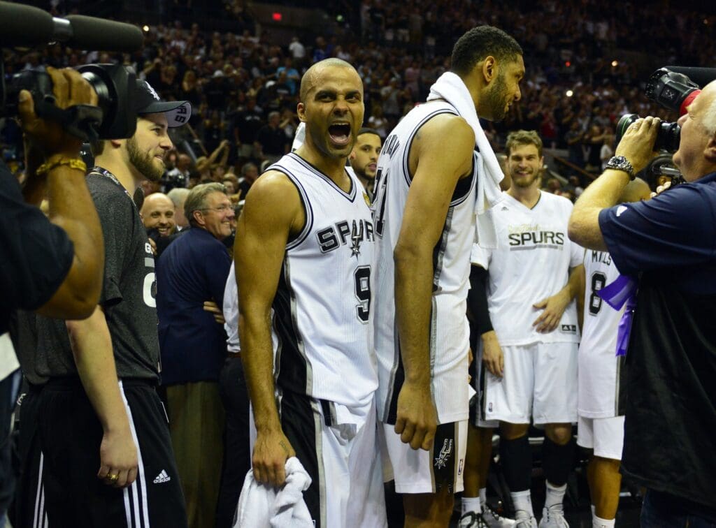 Jun 15, 2014; San Antonio, TX, USA; San Antonio Spurs guard Tony Parker (9) celebrates on the bench in game five of the 2014 NBA Finals against the Miami Heat at AT&T Center. The Spurs beat the Heat 104-87 to win the NBA Finals. Mandatory Credit: Bob Donnan-USA TODAY Sports