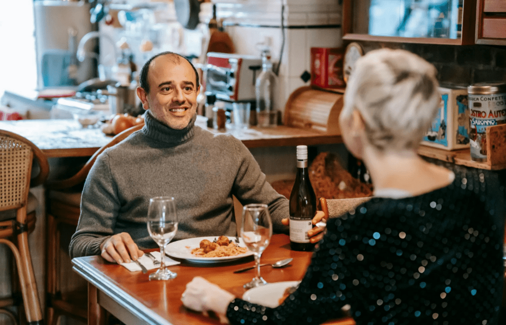 A couple renewing vows or smiling across a dinner table