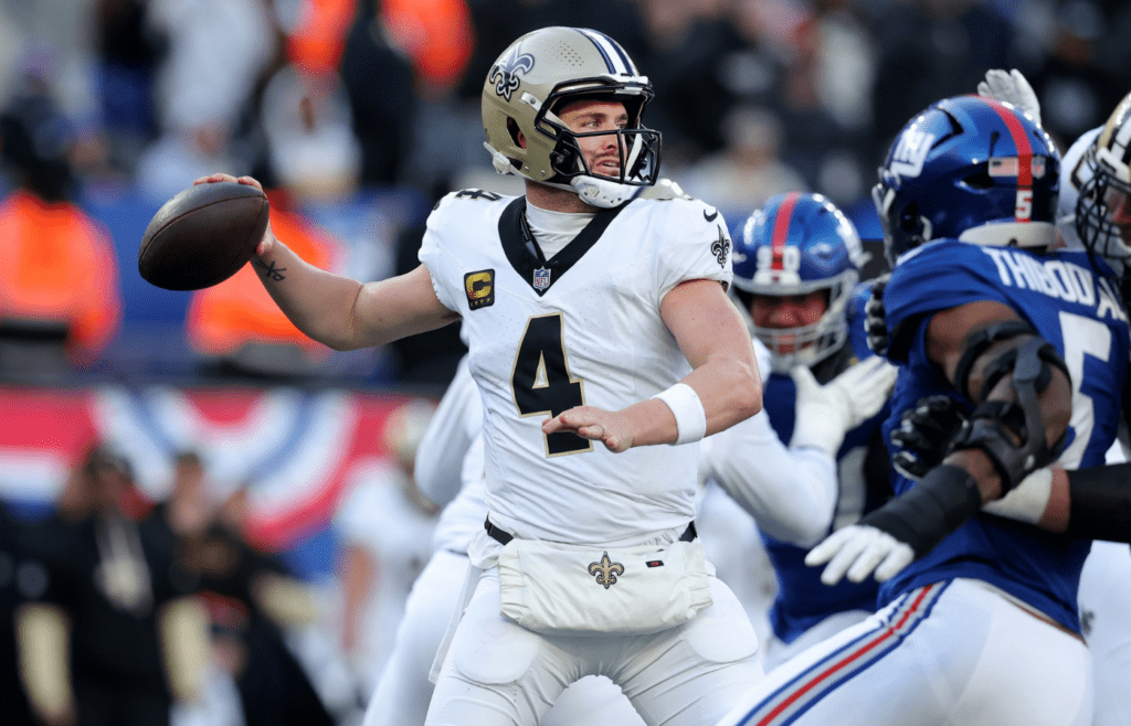 Dec 8, 2024; East Rutherford, New Jersey, USA; New Orleans Saints quarterback Derek Carr (4) drops back to pass against the New York Giants during the third quarter at MetLife Stadium. Mandatory Credit: Brad Penner-Imagn Images