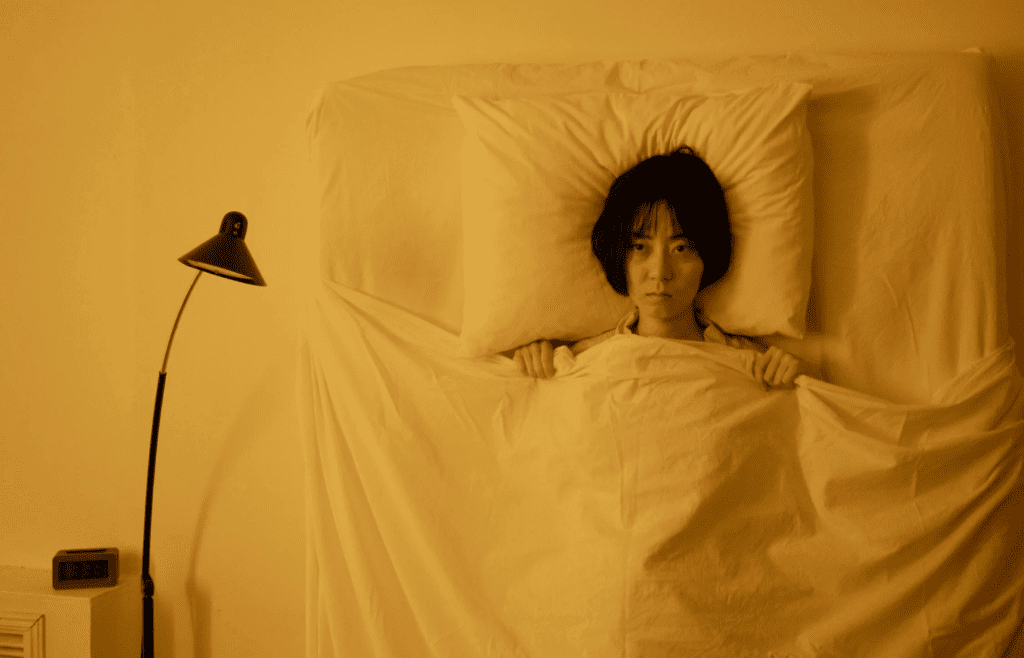 A person reflecting alone with a soft blanket or journal