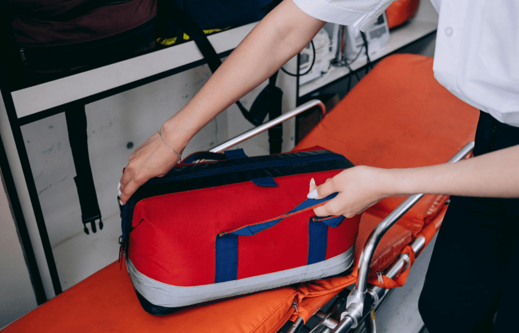 A compact first-aid kit laid out on a picnic table