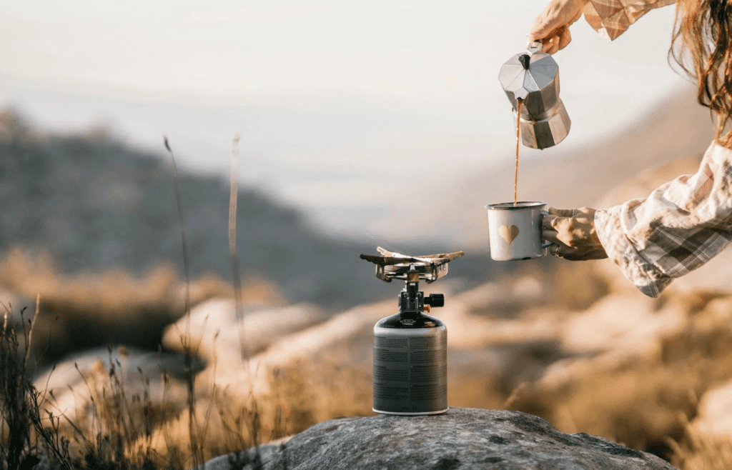 A small camping stove with coffee boiling