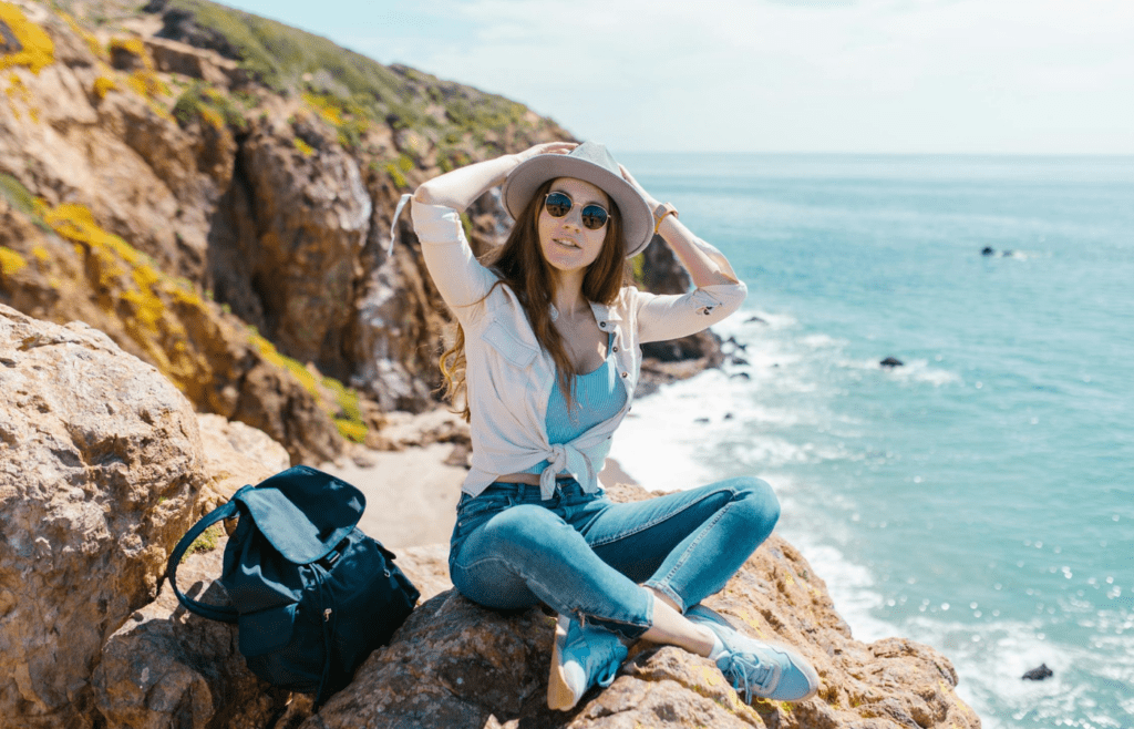 Sunscreen, sunglasses, and a wide-brim hat packed for camping