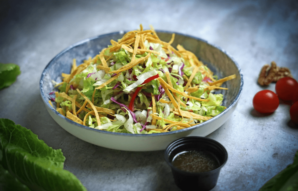 A big bowl of colorful coleslaw with a creamy dressing