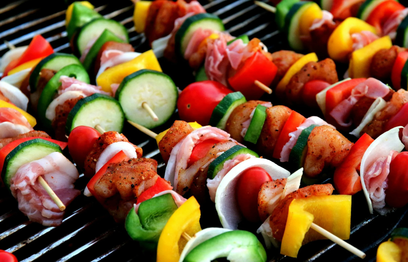 Skewers loaded with colorful grilled vegetables like peppers and zucchini