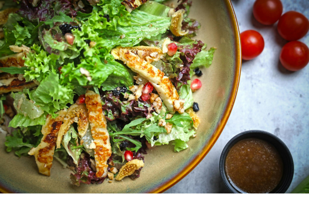 A colorful pasta salad with veggies and vinaigrette